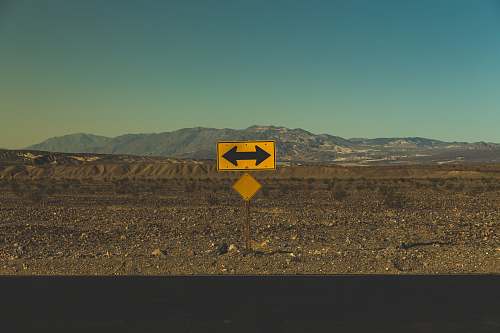 death valley national park yellow arrow road sign furnace creek